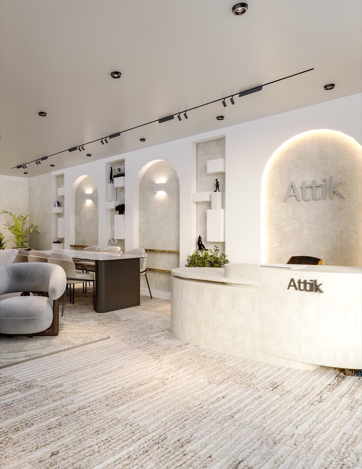 The Attik showroom: grey lounge chairs, a dining table and a curved stone reception desk under an arched Attik sign